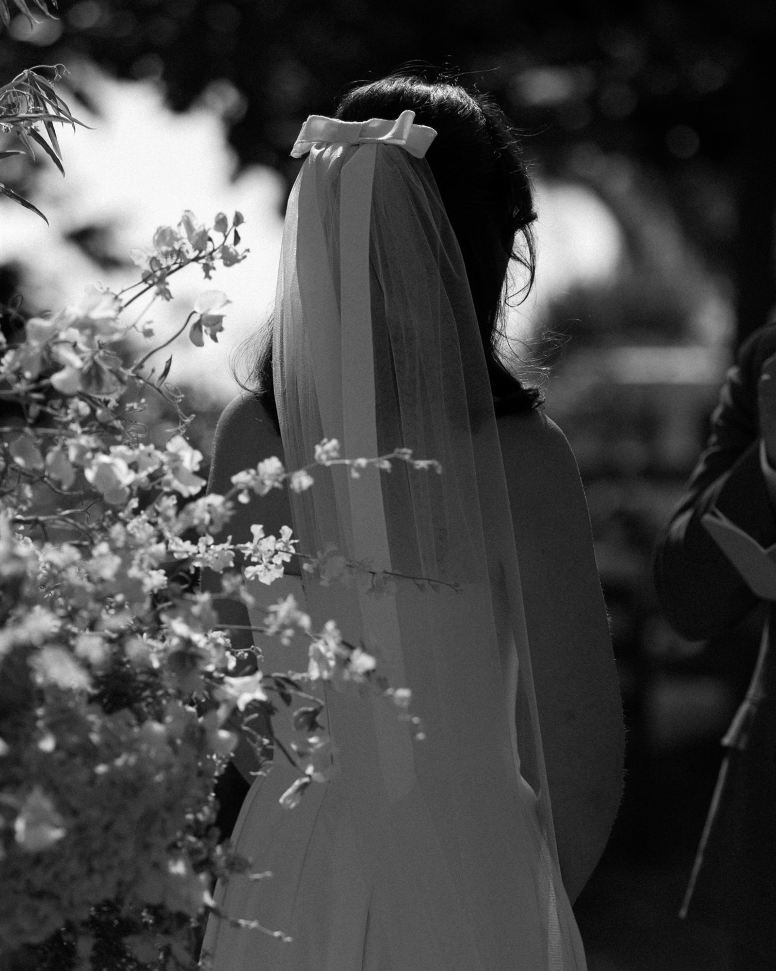 Bride in veil with garden florals, wedding ceremony by Still Carnations